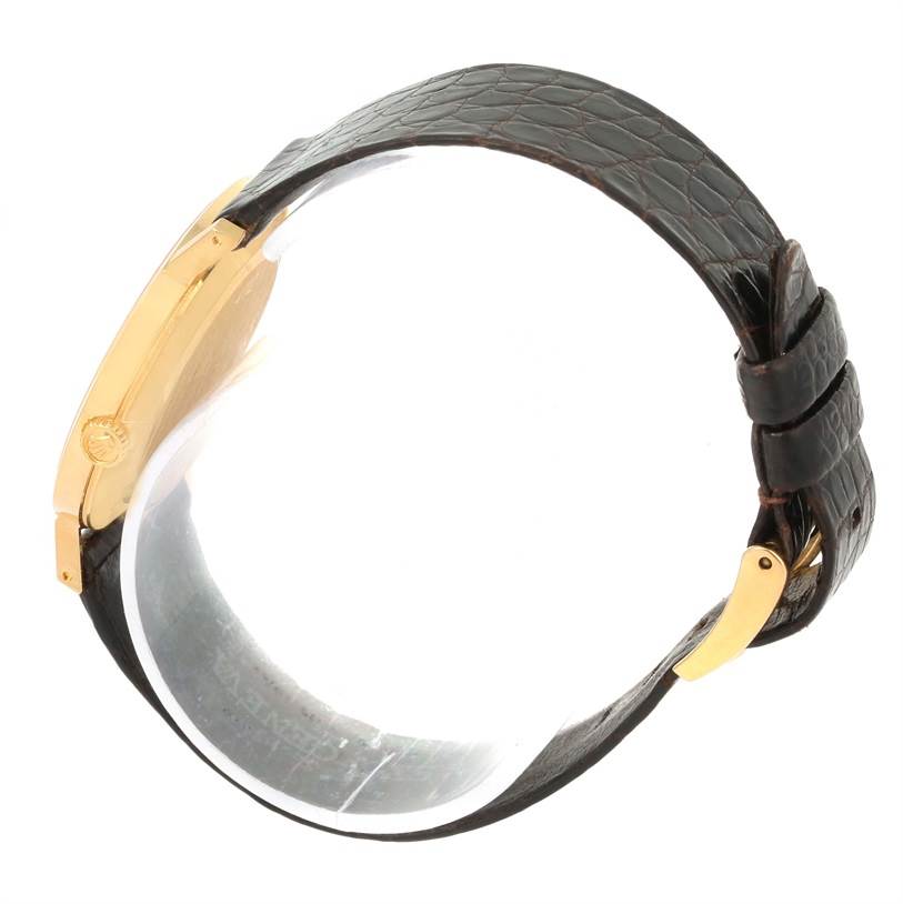 The image shows a side profile of a Rolex Cellini 4112 Men's Yellow Gold Champagne Dial 4112 Men's Yellow Gold Champagne Dial watch, highlighting the gold case, leather strap, and buckle.