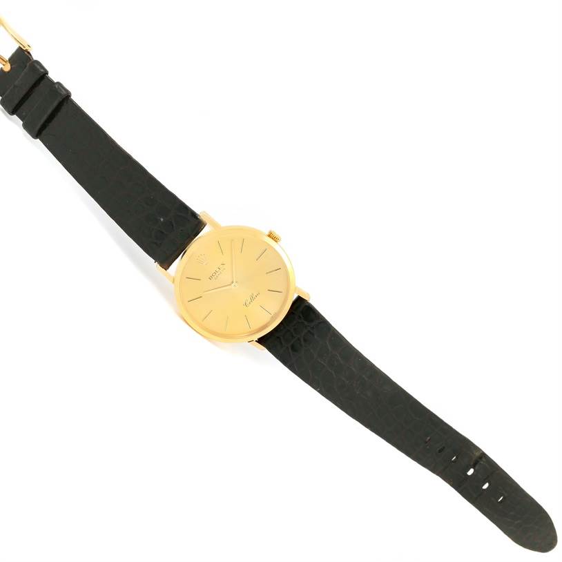 The image shows a Rolex Cellini 4112 Men's Yellow Gold Champagne Dial 4112 Men's Yellow Gold Champagne Dial watch from a top-down angle, displaying the gold case, dial, crown, and black leather strap.