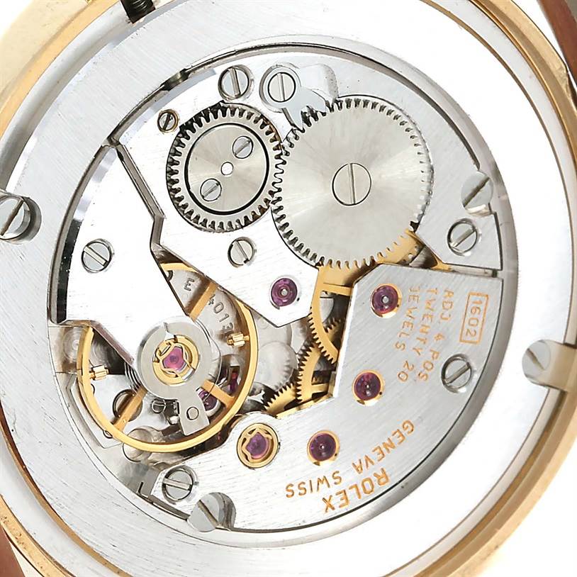The image displays the intricate movement mechanism of a Rolex Cellini 5115 Men
s Yellow Gold Beige Dial 5115 Men
s Yellow Gold Beige Dial watch, viewed from the back.