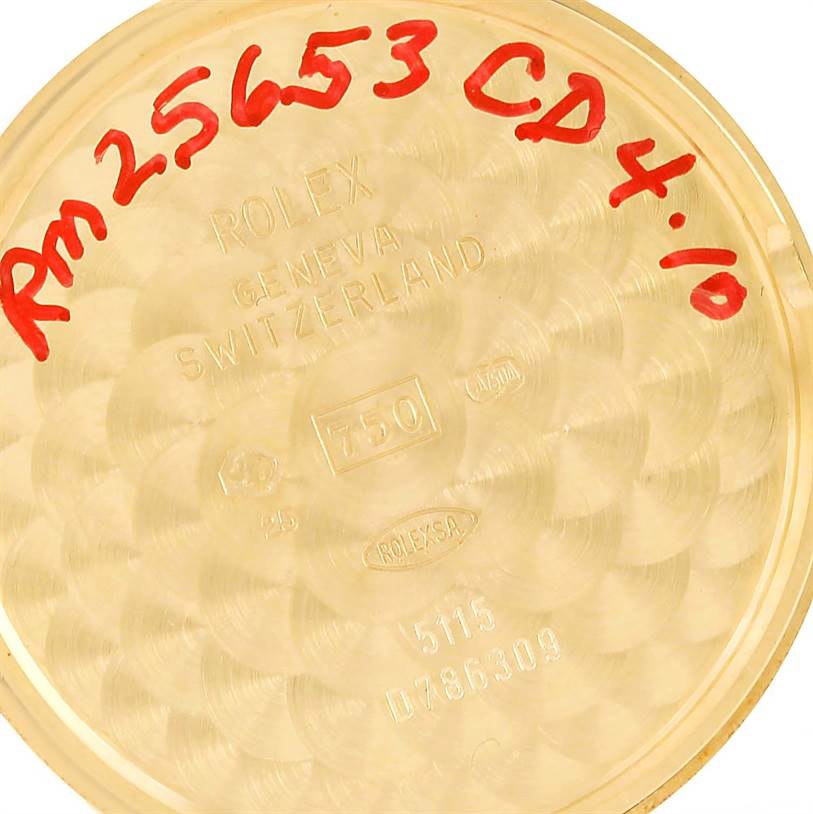 This is a close-up view of the back casing of a Rolex Cellini 5115 Men
s Yellow Gold Beige Dial 5115 Men
s Yellow Gold Beige Dial watch with red handwritten markings.