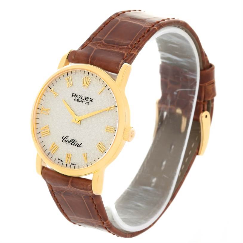 The image shows a side and partial front view of a Rolex Cellini 5115 Men
s Yellow Gold Beige Dial 5115 Men
s Yellow Gold Beige Dial watch with a brown leather strap and a gold case.