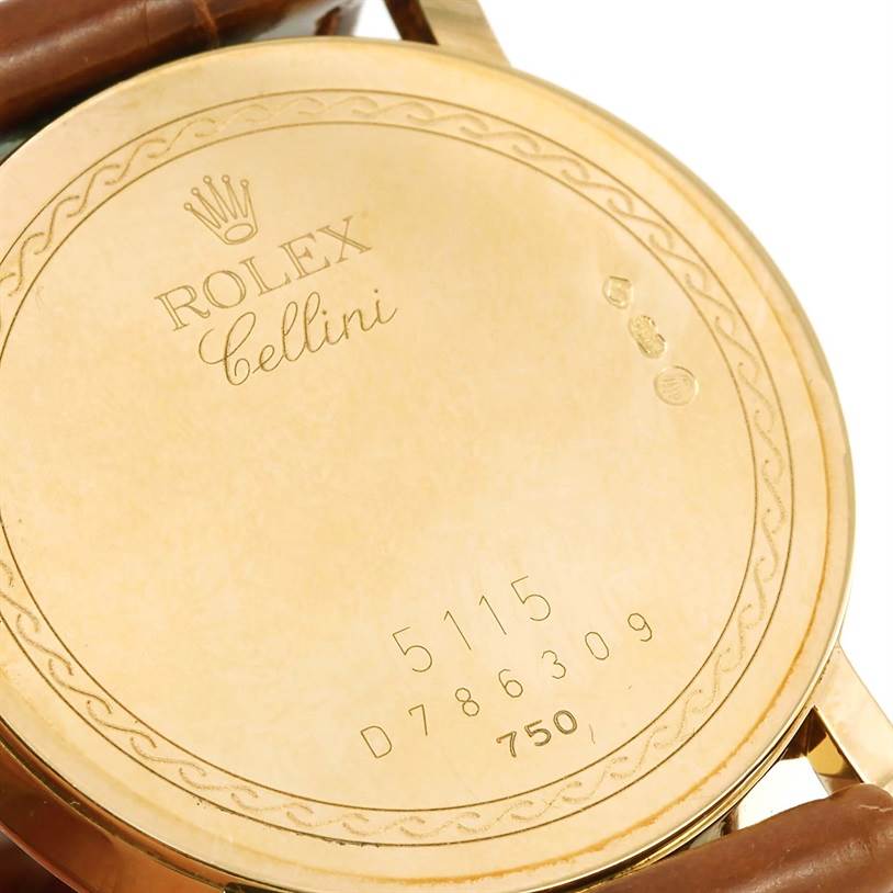 The image shows the engraved back case of a Rolex Cellini 5115 Men
s Yellow Gold Beige Dial 5115 Men
s Yellow Gold Beige Dial watch, including the model number and other engravings.