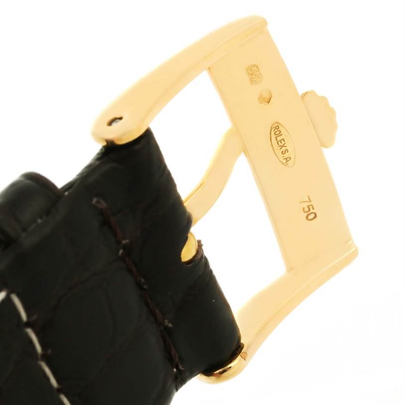 The image shows a close-up of a gold buckle and black leather strap of a Rolex Cellini 5116 Men
s Yellow Gold Silver Dial 5116 Men
s Yellow Gold Silver Dial watch.