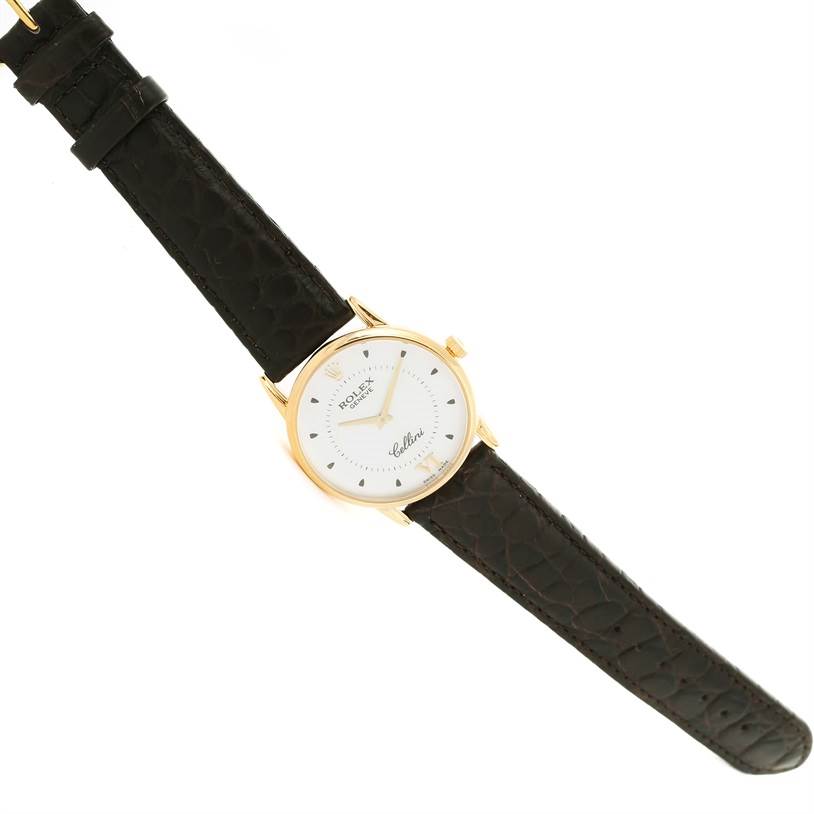 This is a Rolex Cellini 5116 Men
s Yellow Gold Silver Dial 5116 Men
s Yellow Gold Silver Dial watch shown from a top-down angle, displaying its face and entire strap.