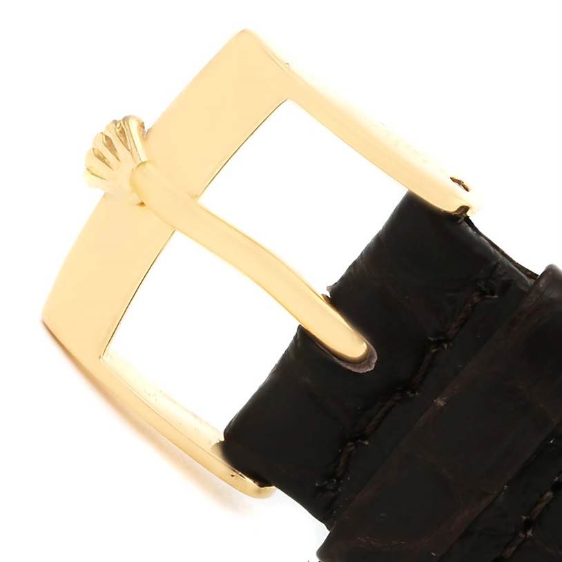 This image shows a close-up of the gold buckle and black leather strap of a Rolex Cellini 5116 Men
s Yellow Gold Silver Dial 5116 Men
s Yellow Gold Silver Dial watch.