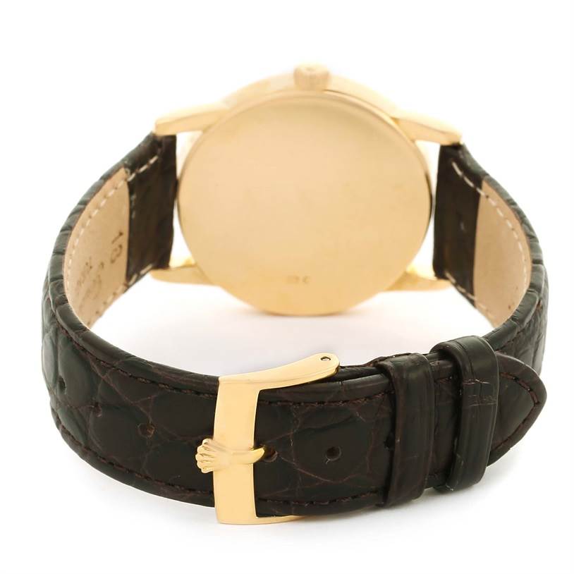 This image shows the back of the Rolex Cellini 5116 Men
s Yellow Gold Silver Dial 5116 Men
s Yellow Gold Silver Dial watch, focusing on the leather strap and gold buckle.