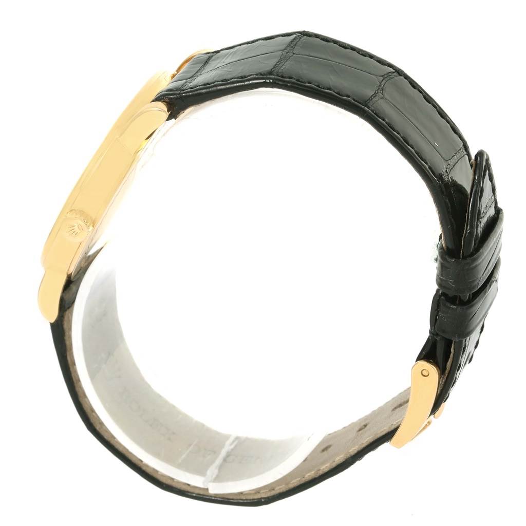 This side view of the Rolex Cellini 5115 Men's Yellow Gold Mother of Pearl Dial 5115 Men's Yellow Gold Mother of Pearl Dial shows the watch case and black leather strap with gold buckle.