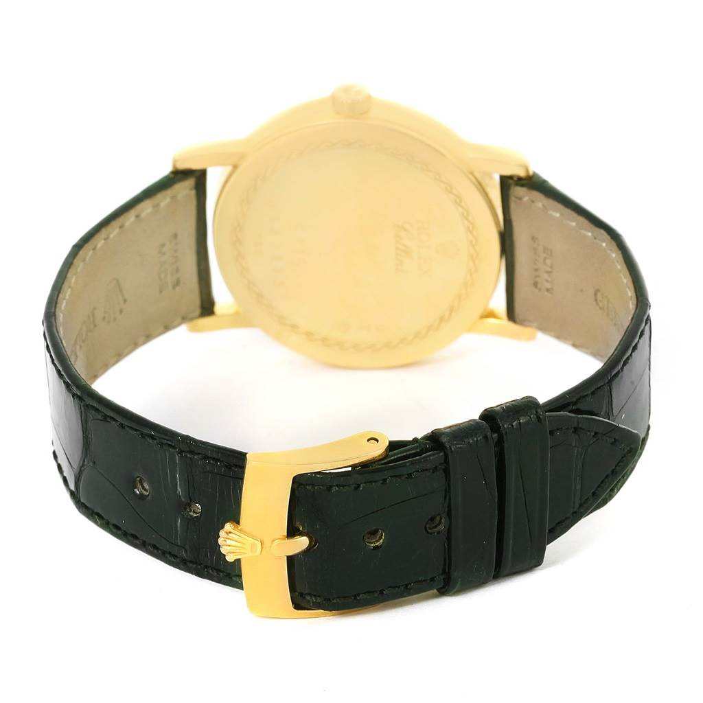 The image shows the back view of a Rolex Cellini 5115 Men's Yellow Gold Mother of Pearl Dial 5115 Men's Yellow Gold Mother of Pearl Dial watch, highlighting its gold case and black leather strap with a gold clasp.