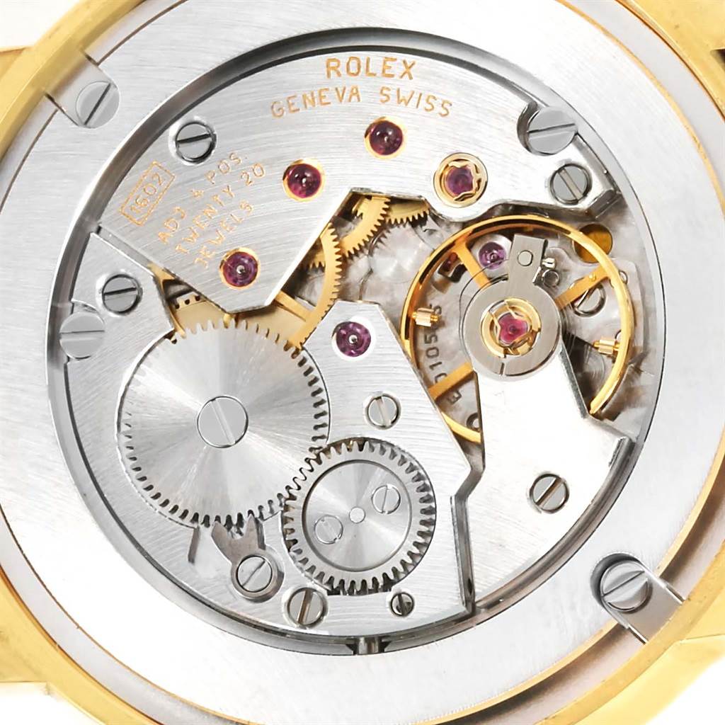 The image shows the movement mechanism of a Rolex Cellini 5115 Men
s Yellow Gold Silver Dial 5115 Men
s Yellow Gold Silver Dial watch from a back angle, highlighting gears and intricate components.