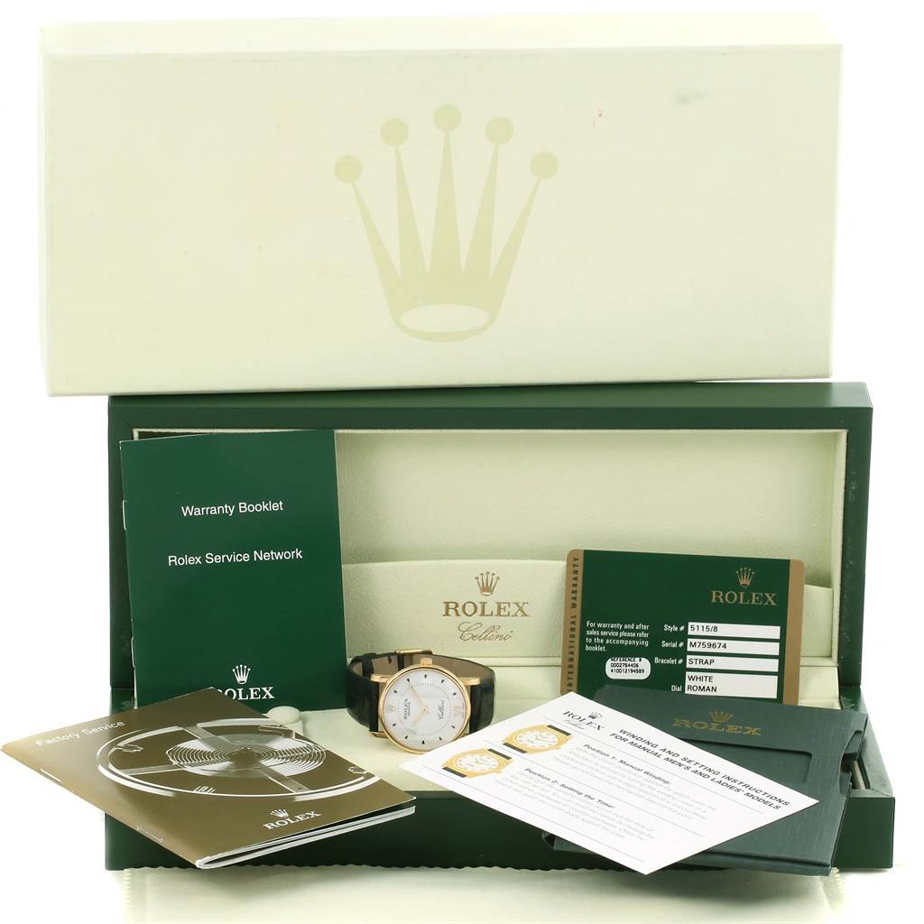 The image shows a Rolex Cellini 5115 Men
s Yellow Gold Silver Dial 5115 Men
s Yellow Gold Silver Dial watch with its box, warranty booklet, service booklet, and other documentation, taken from a front angle.