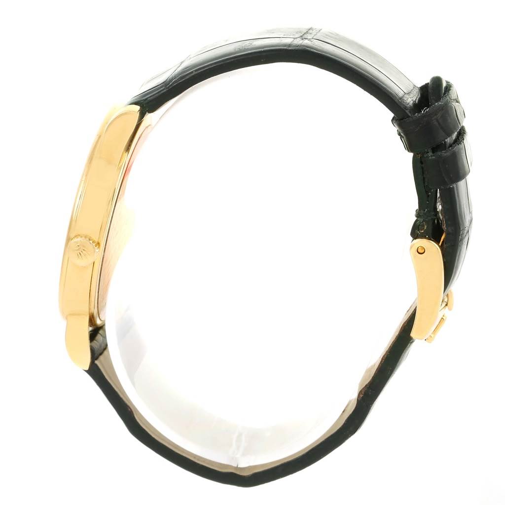 This image shows a side view of the Rolex Cellini 5115 Men
s Yellow Gold Silver Dial 5115 Men
s Yellow Gold Silver Dial watch, highlighting the gold casing, crown, and black leather strap.