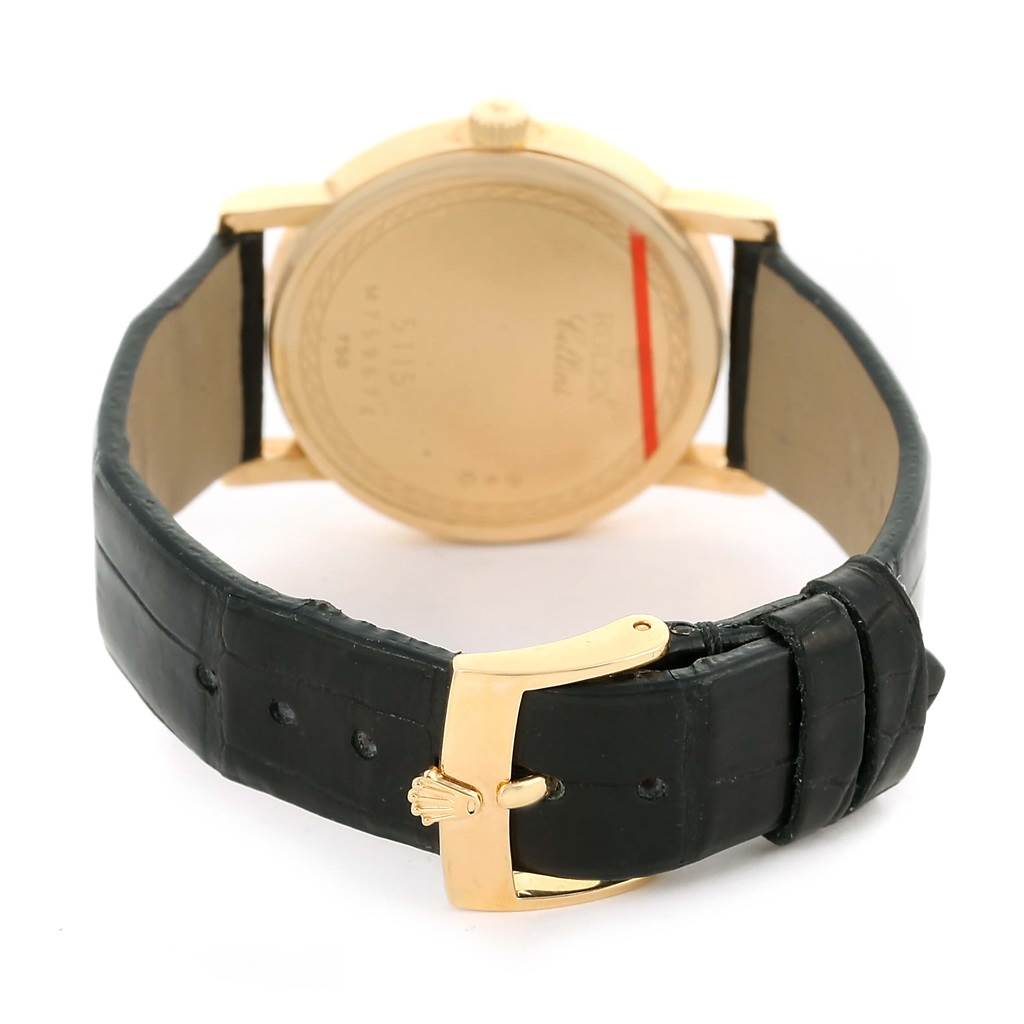 The image shows the back view of a Rolex Cellini 5115 Men
s Yellow Gold Silver Dial 5115 Men
s Yellow Gold Silver Dial watch, highlighting the case back and leather strap with buckle.