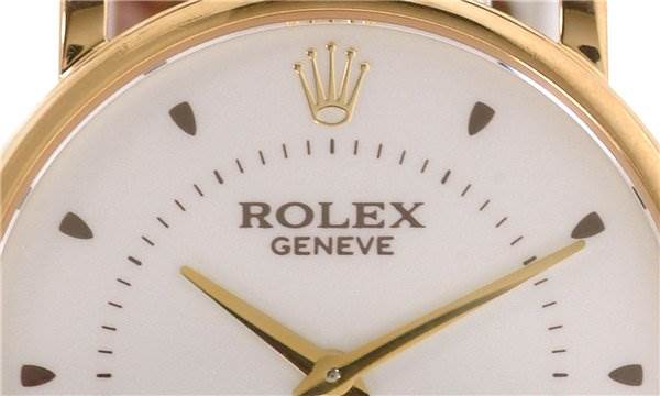 This image shows a close-up of the dial of a Rolex Cellini 5115 Men's Yellow Gold Silver Dial 5115 Men's Yellow Gold Silver Dial watch, highlighting the Rolex logo, brand name, and gold hands.