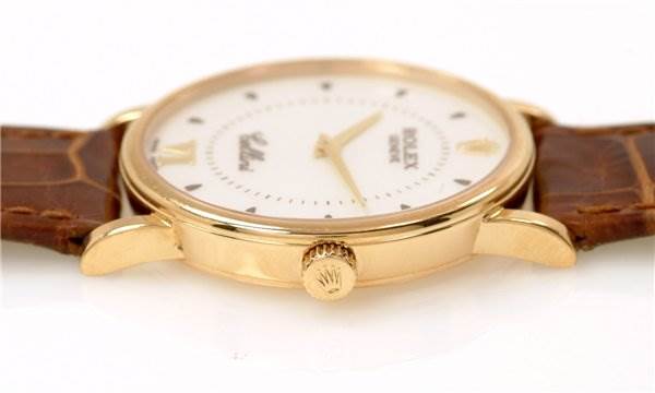 This image shows a close-up, side angle of the Rolex Cellini 5115 Men's Yellow Gold Silver Dial 5115 Men's Yellow Gold Silver Dial watch, focusing on the crown and part of the leather strap.