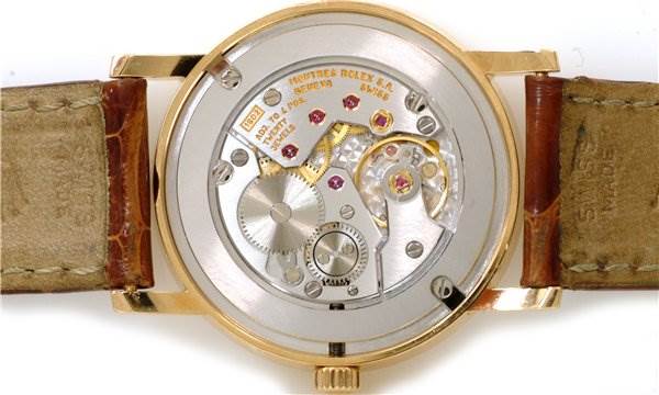 The image shows the back view of the Rolex Cellini 5115 Men's Yellow Gold Silver Dial 5115 Men's Yellow Gold Silver Dial watch, highlighting its mechanical movement and internal components.