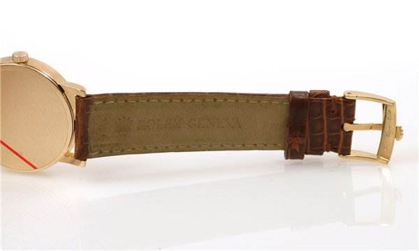 This Cellini model Rolex watch is shown from a side angle, featuring the strap and buckle.