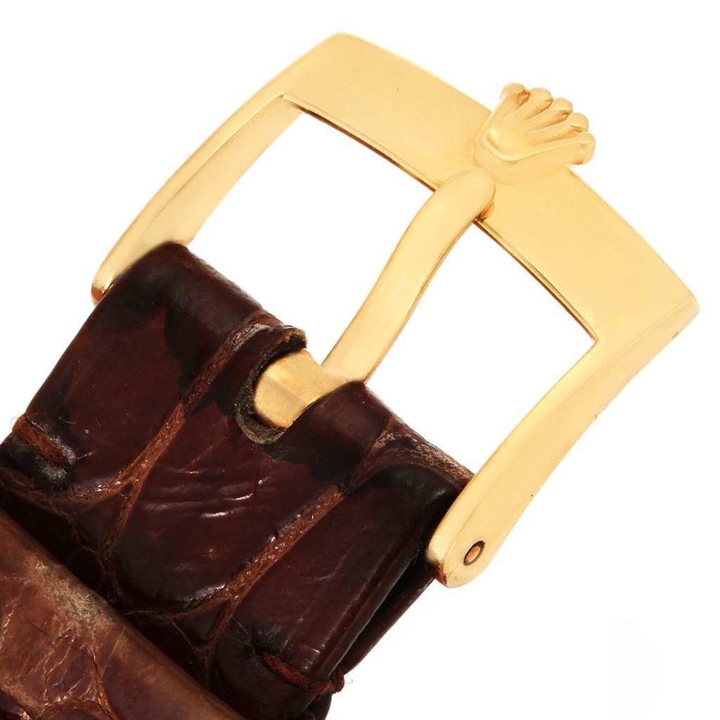 The image shows a close-up of the gold buckle and brown leather strap of a Rolex Cellini 5116 Men's Yellow Gold Grey Dial 5116 Men's Yellow Gold Grey Dial watch.