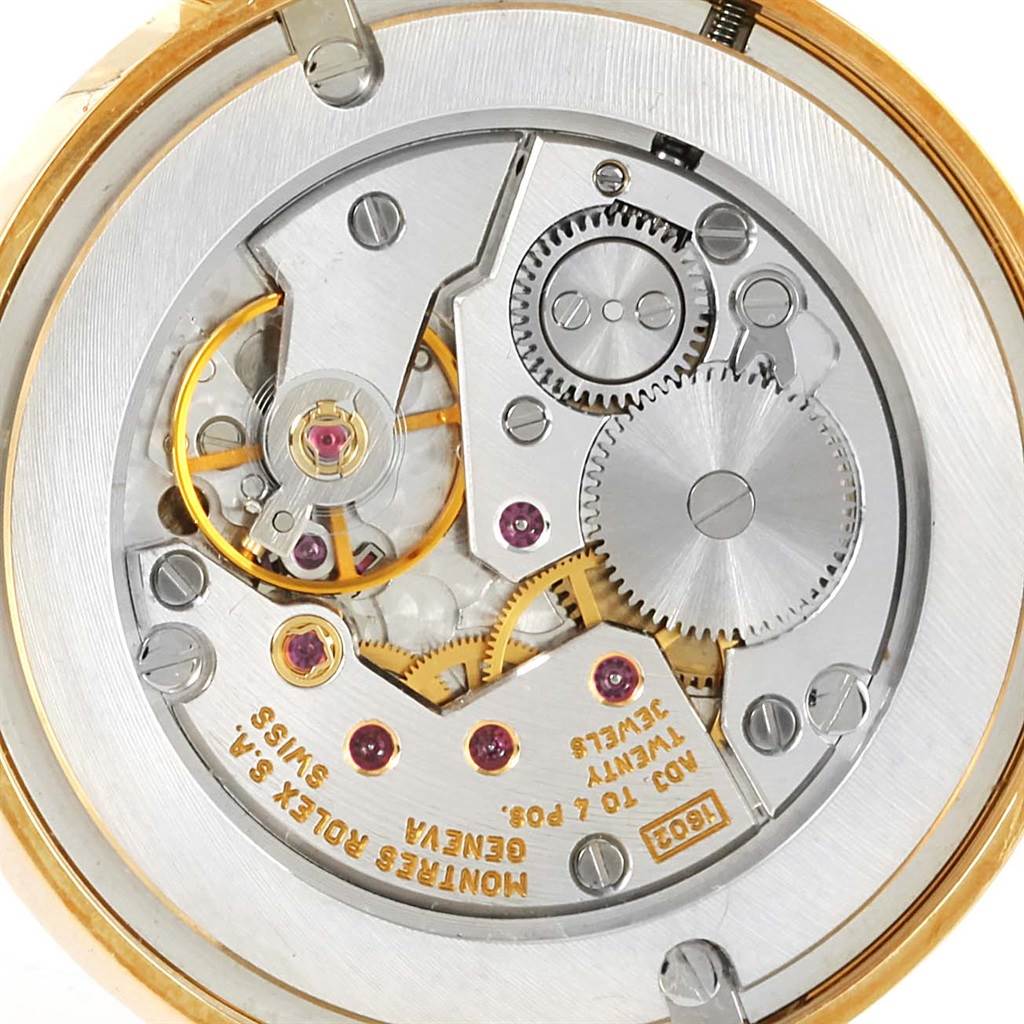 This image shows the intricate internal mechanism of the Rolex Cellini 5116 Men's Yellow Gold Grey Dial 5116 Men's Yellow Gold Grey Dial watch, focusing on the movement and gears from the back view.