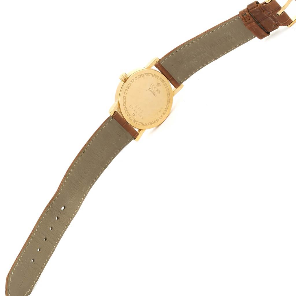 The image shows the back view of a Rolex Cellini 5115 Men
s Yellow Gold Beige Dial 5115 Men
s Yellow Gold Beige Dial watch, featuring its case back and leather straps.