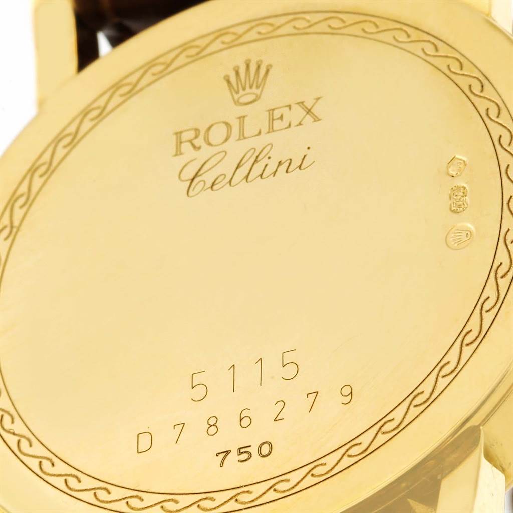 This image shows the engraved back case of a Rolex Cellini 5115 Men
s Yellow Gold Beige Dial 5115 Men
s Yellow Gold Beige Dial watch, including its serial and model numbers.