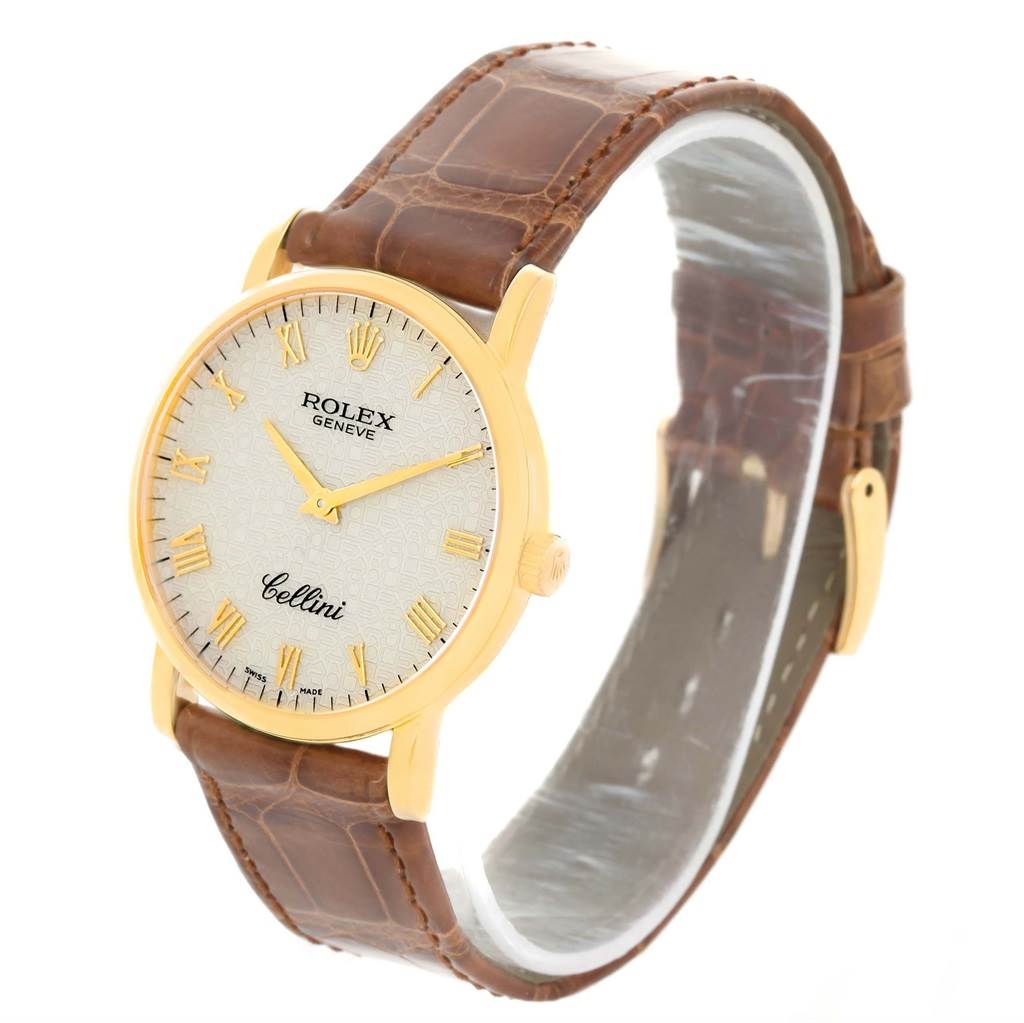 The Rolex Cellini 5115 Men
s Yellow Gold Beige Dial 5115 Men
s Yellow Gold Beige Dial watch is shown at an angled side view, displaying the face, case, and brown leather strap.