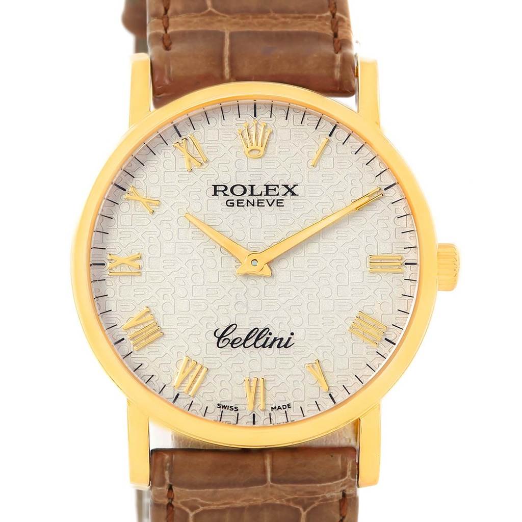 The image shows a front view of a Rolex Cellini 5115 Men
s Yellow Gold Beige Dial 5115 Men
s Yellow Gold Beige Dial watch with a gold case, Roman numerals, and a brown leather strap.