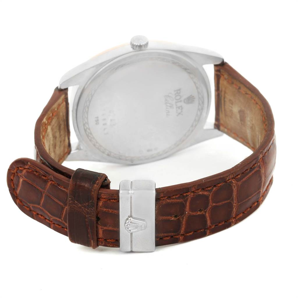 The image shows the back of a Rolex Cellini 4243 Men's White Gold White Dial 4243 Men's White Gold White Dial watch with a brown leather strap and a clasp featuring the Rolex logo.
