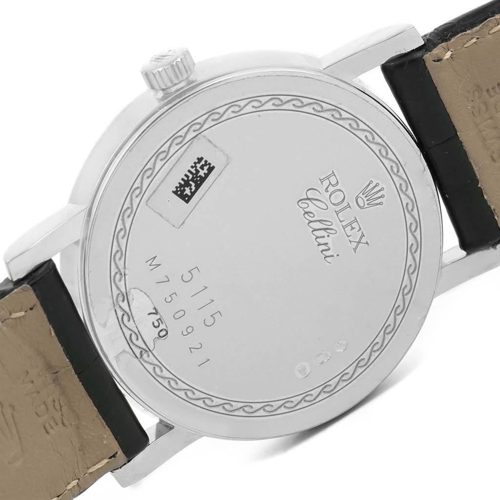 The image shows the back case and part of the leather strap of a Rolex Cellini 5115 Men's White Gold Black Dial 5115 Men's White Gold Black Dial watch.