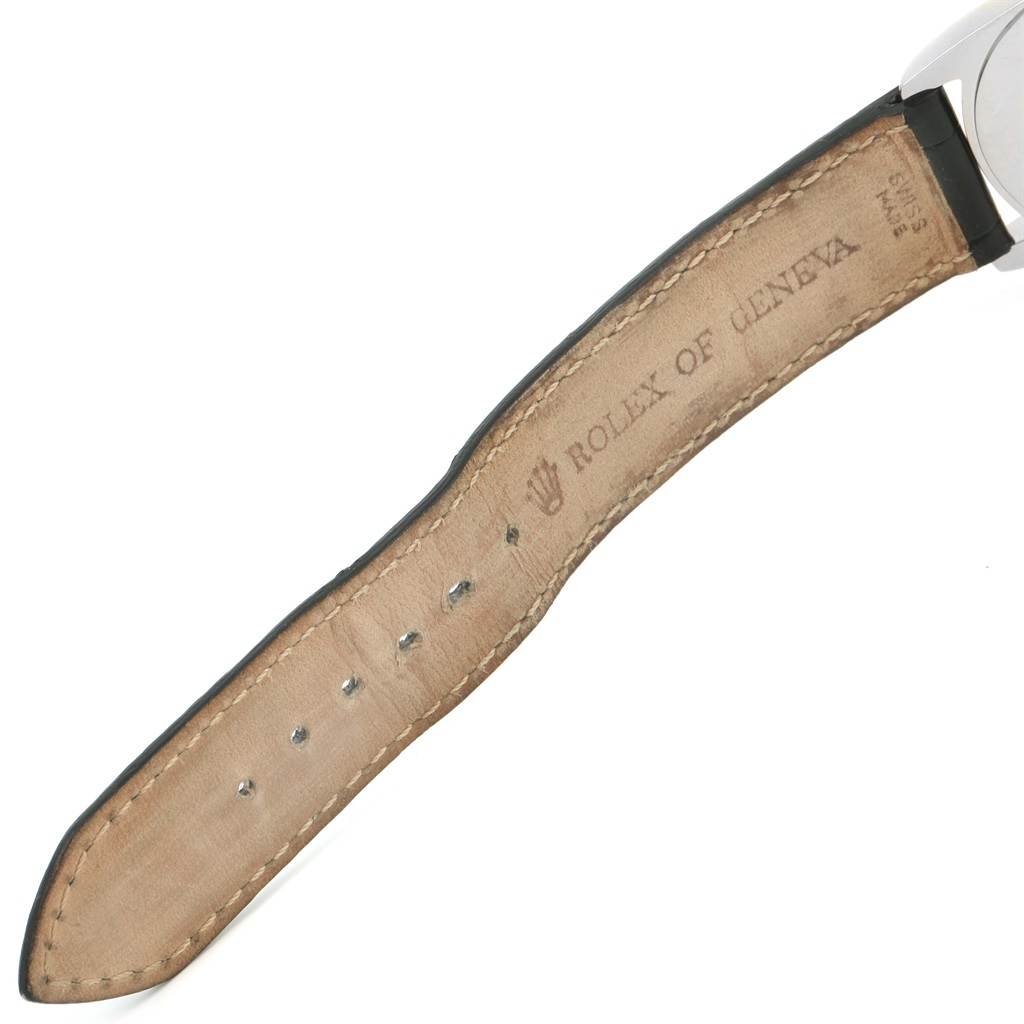 The image shows the back side of the strap and a partial view of the case of a Rolex Cellini 4233 Men's White Gold Black Dial 4233 Men's White Gold Black Dial watch.