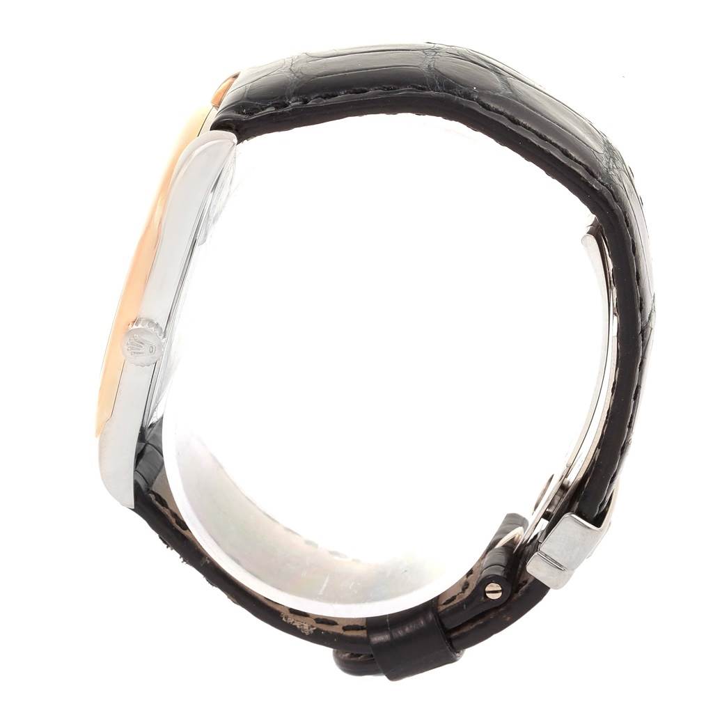 This side view of the Rolex Cellini 4243 Men
s White Gold Black Dial 4243 Men
s White Gold Black Dial watch shows the crown, case, and leather strap with a buckle.