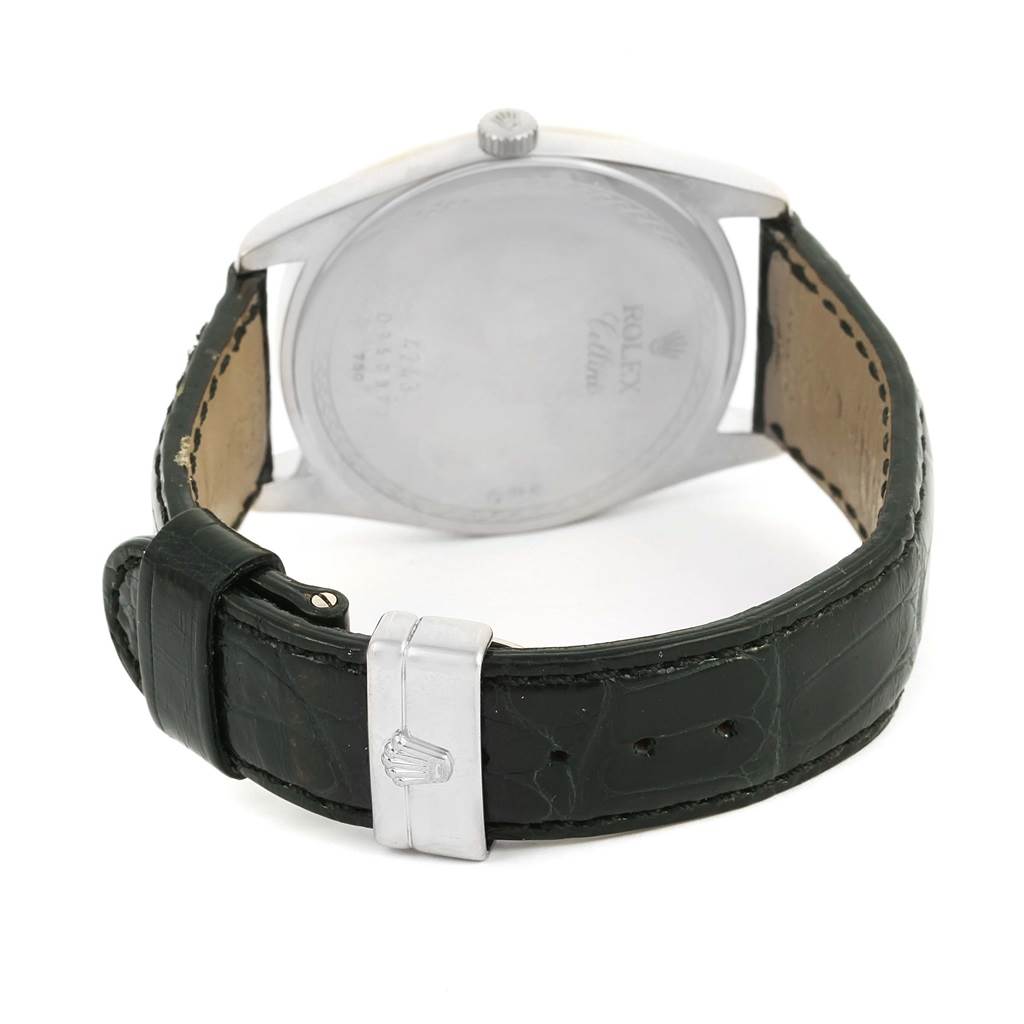 The image shows the back view of a Rolex Cellini 4243 Men
s White Gold Black Dial 4243 Men
s White Gold Black Dial watch, highlighting the case back, crown, and black leather strap with a clasp.
