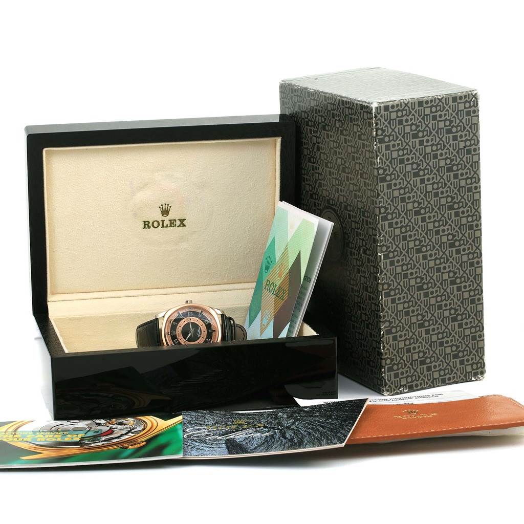 A Rolex Cellini 4243 Men
s White Gold Black Dial 4243 Men
s White Gold Black Dial watch is shown in its open box, accompanied by documentation and an outer box in the background.
