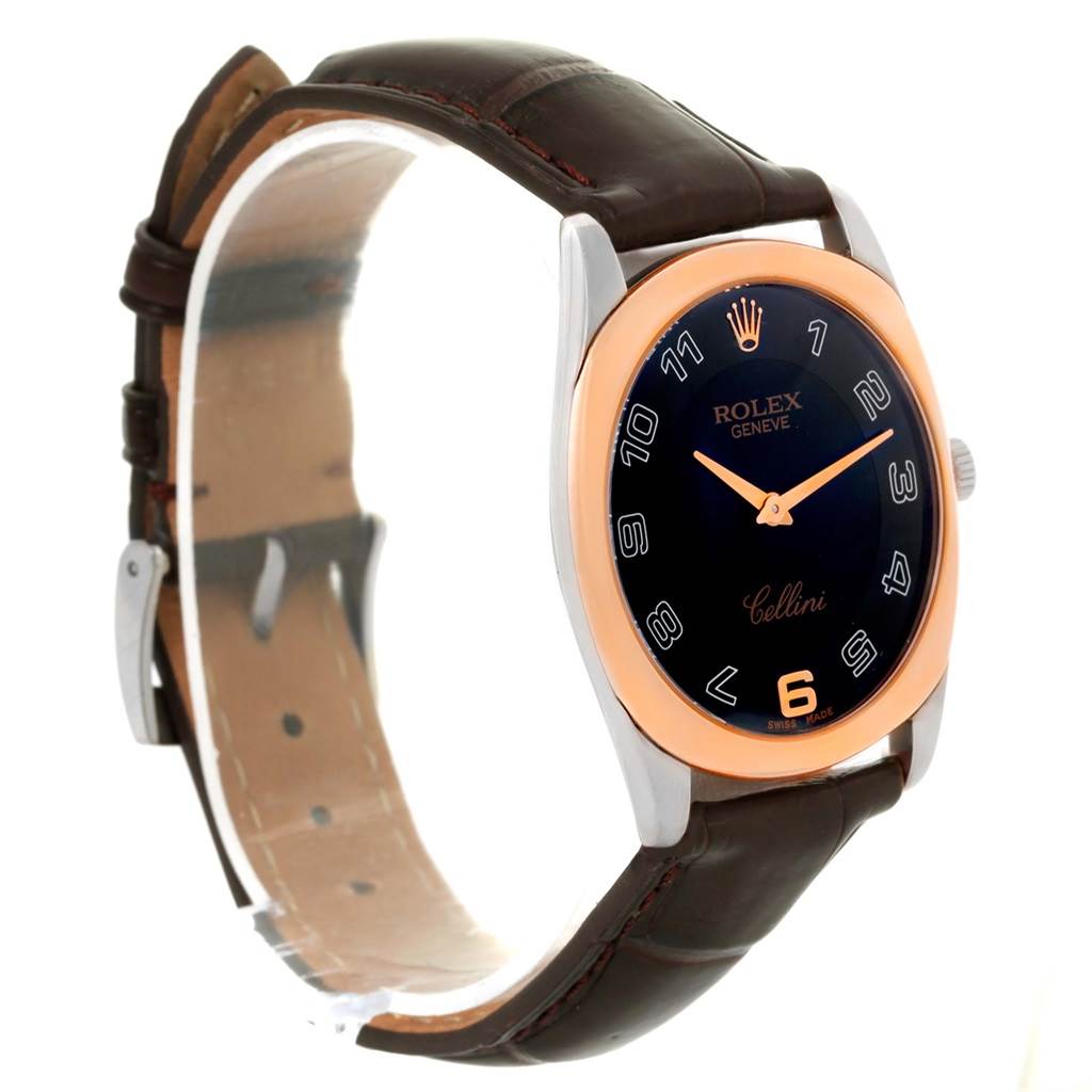 The image shows a Rolex Cellini 4233 Men
s White Gold Black Dial 4233 Men
s White Gold Black Dial watch from a side angle, highlighting its black dial, rose gold bezel, and brown leather strap.