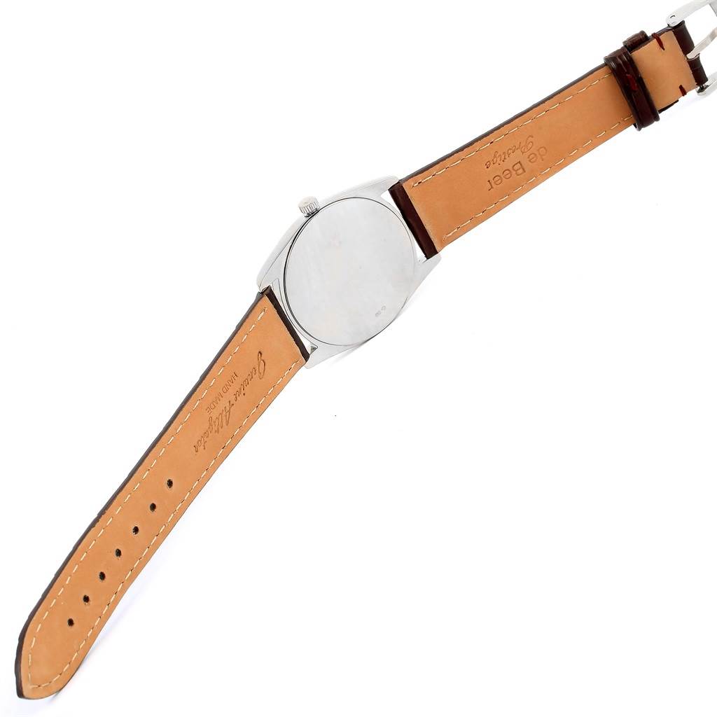 The image shows the backside and the leather strap of a Rolex Cellini 4233 Men
s White Gold Black Dial 4233 Men
s White Gold Black Dial model watch at an angled view.