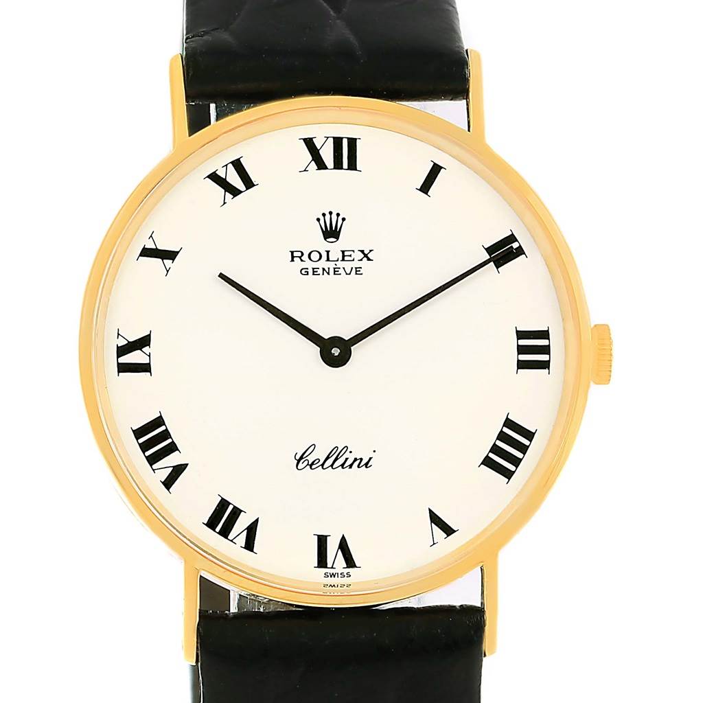 The Rolex Cellini 3833 Yellow Gold White Dial 3833 Yellow Gold White Dial watch is shown from a front angle, showcasing its face, Roman numerals, and black leather strap.