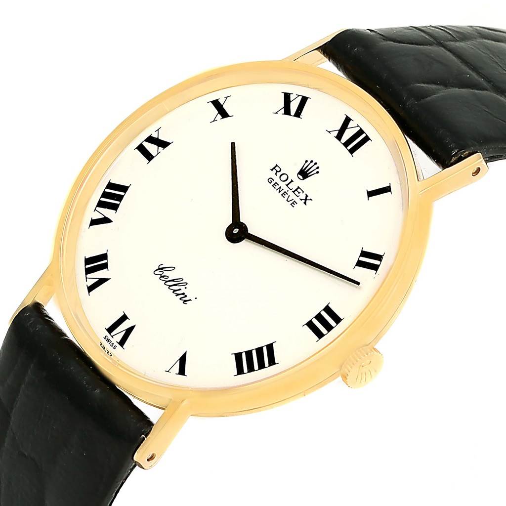 This image shows a Rolex Cellini 3833 Yellow Gold White Dial 3833 Yellow Gold White Dial watch at a slight angle, highlighting the face, Roman numerals, gold case, and black leather strap.