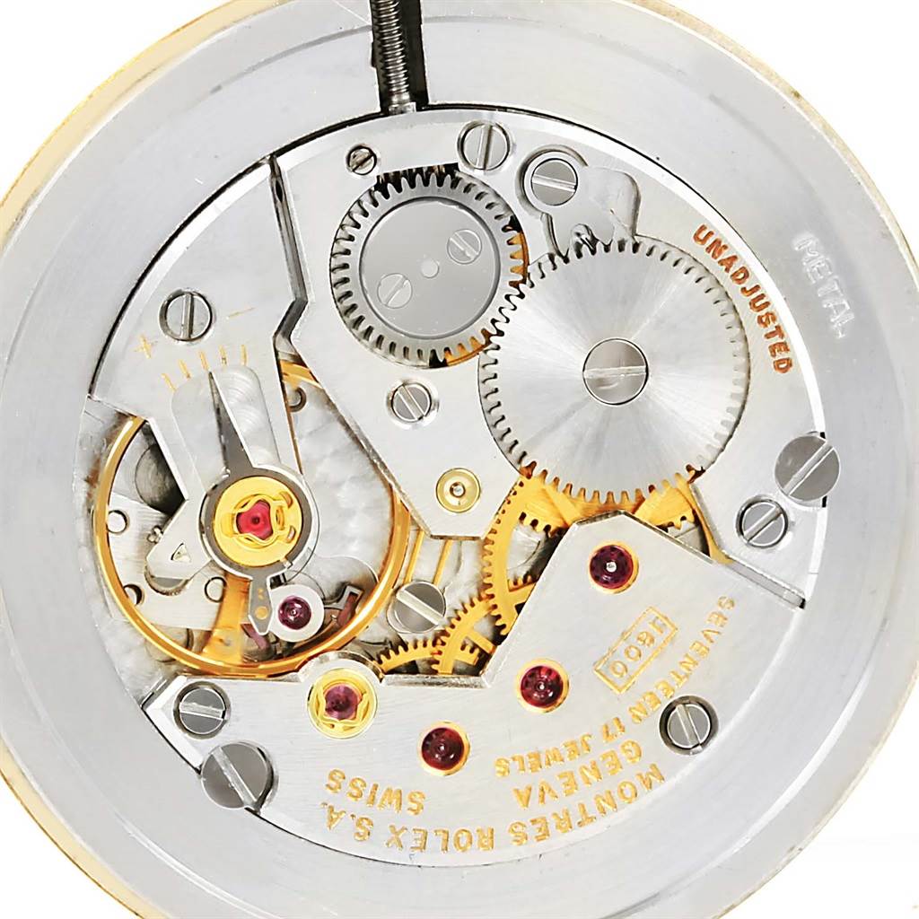 This image shows an inside view of the Rolex Cellini 3833 Yellow Gold White Dial 3833 Yellow Gold White Dial watch movement, displaying gears and intricate mechanical parts.