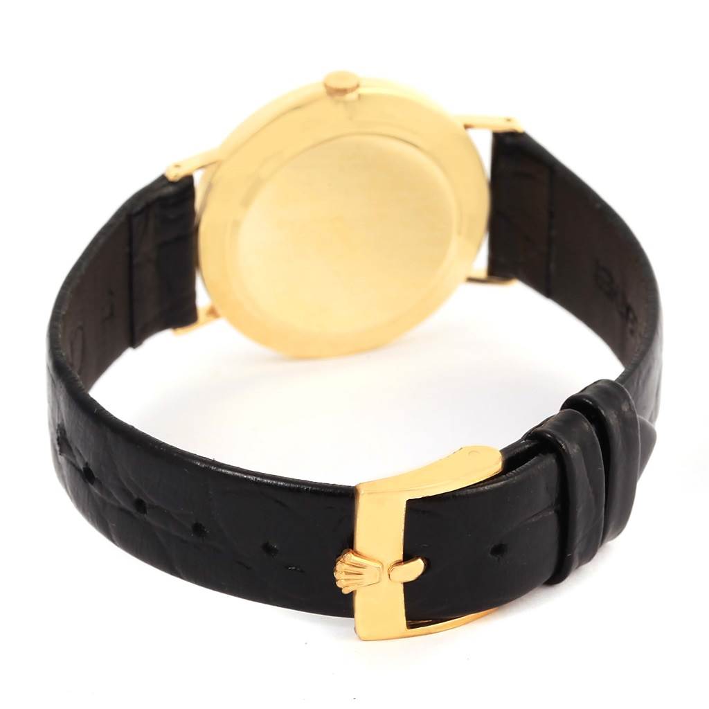 The image shows the back view of a Rolex Cellini 3833 Yellow Gold White Dial 3833 Yellow Gold White Dial watch, focusing on the gold case and black leather strap with a gold buckle.