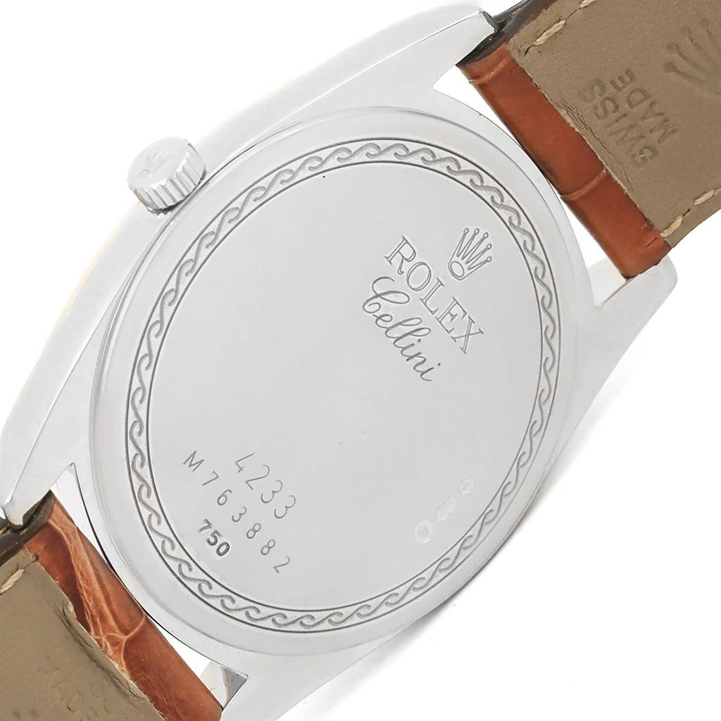 The image shows the back case and a portion of the strap of a Rolex Cellini 4233 Men
s White Gold Black Dial 4233 Men
s White Gold Black Dial watch.