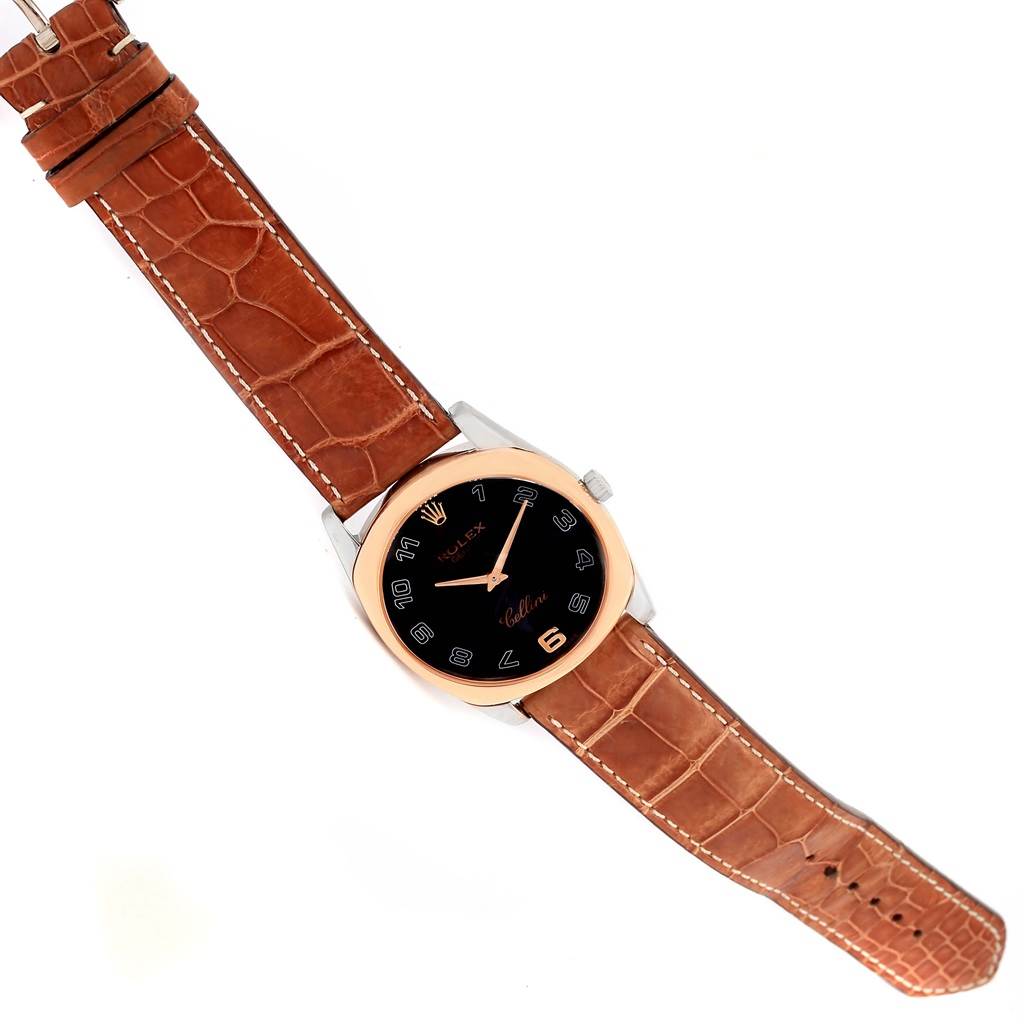 The Rolex Cellini 4233 Men
s White Gold Black Dial 4233 Men
s White Gold Black Dial watch is shown from a top-down angle, highlighting its dial, case, crown, and leather strap.