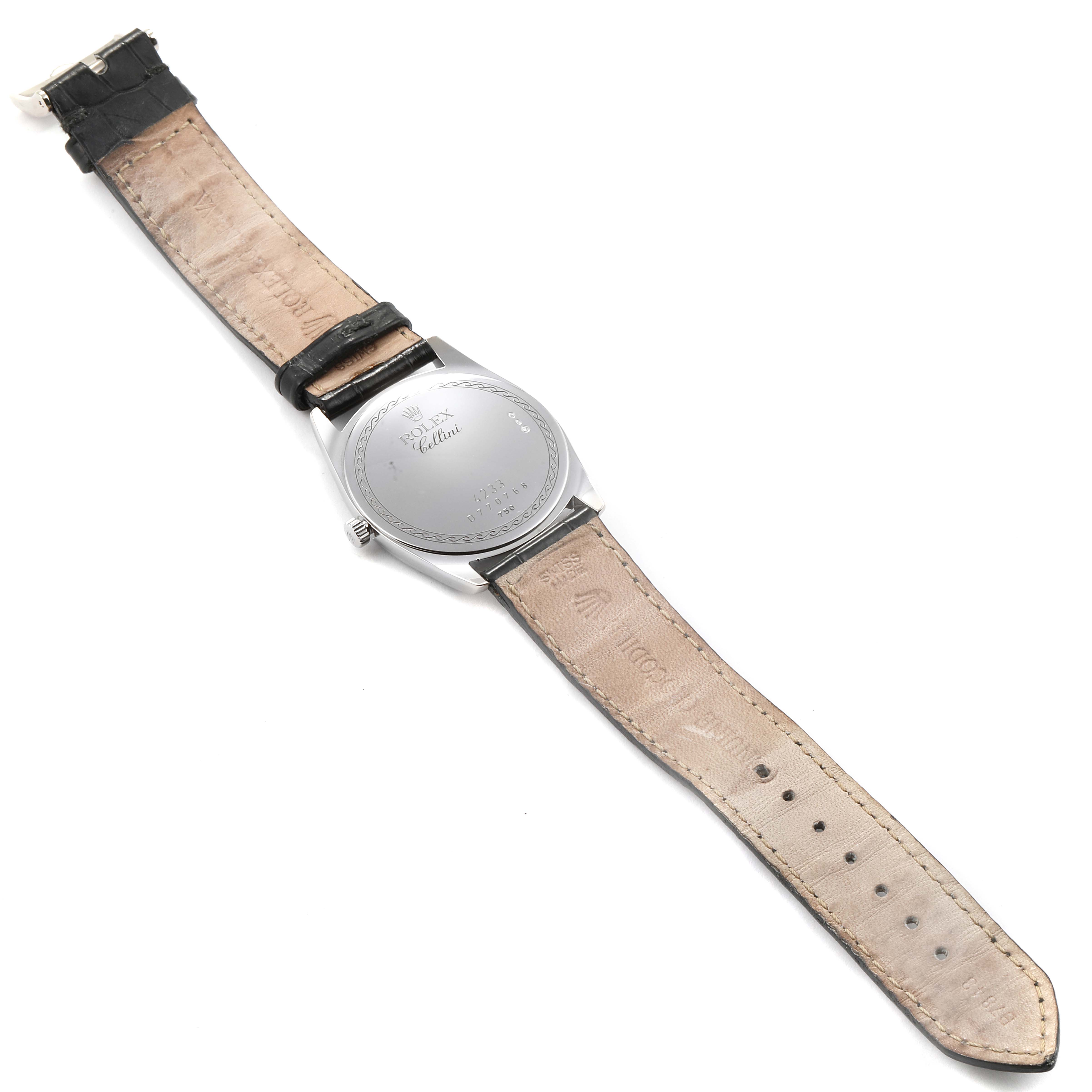 The image shows the backside and strap of a Rolex Cellini 4233 Men
s White Gold Black Dial 4233 Men
s White Gold Black Dial watch, highlighting its leather band and engraved case back.