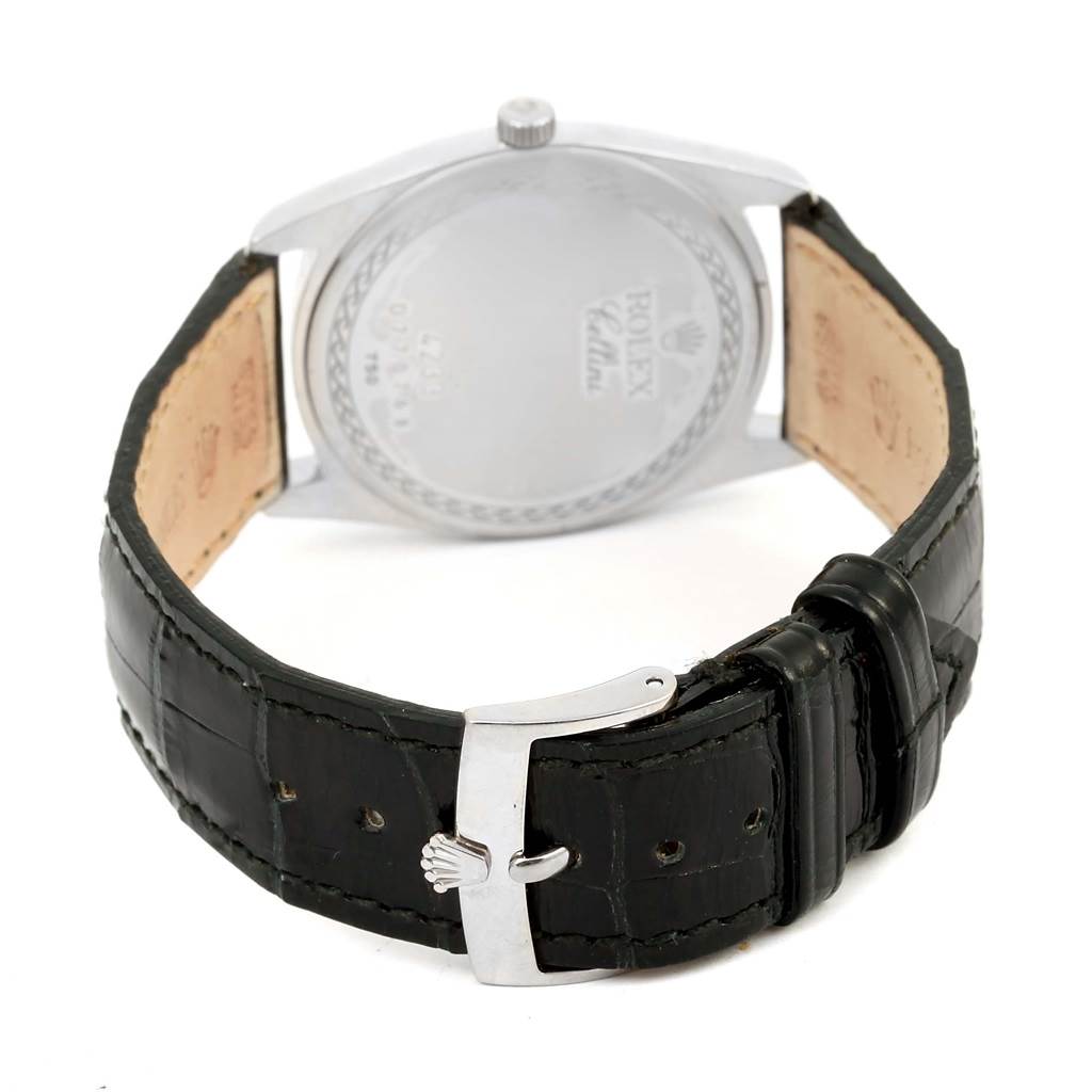 The image shows the back and buckle of a Rolex Cellini 4233 Men
s White Gold Black Dial 4233 Men
s White Gold Black Dial watch with a leather strap and visible branding.