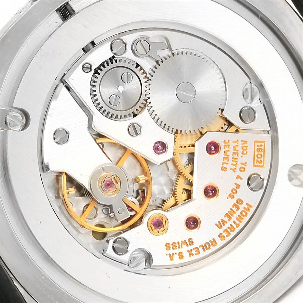 The image shows the inner mechanical components of a Rolex Cellini 4233 Men's White Gold Black Dial 4233 Men's White Gold Black Dial watch, including gears and the movement mechanism.