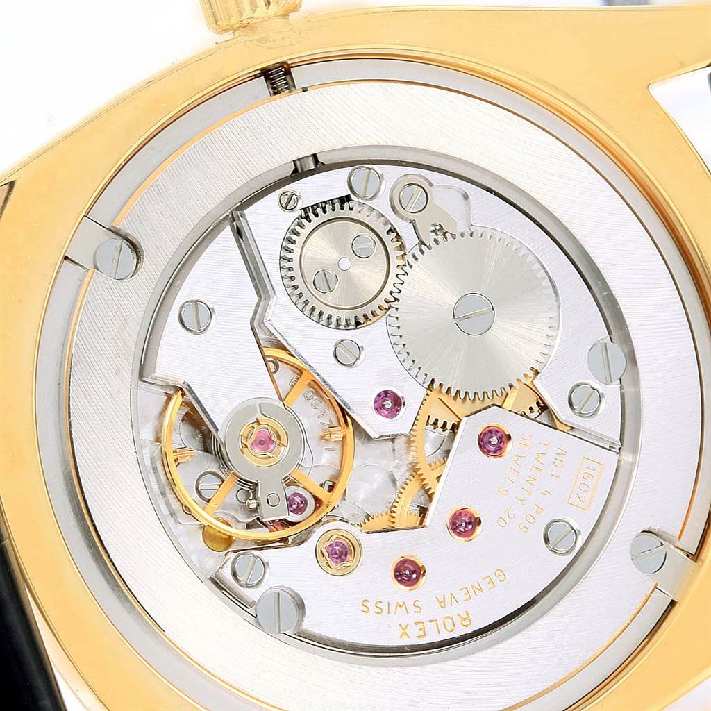 This is a close-up view of the movement mechanism of a Rolex Cellini 4233 Men's Yellow Gold White Dial 4233 Men's Yellow Gold White Dial watch, showing gears and intricate details.