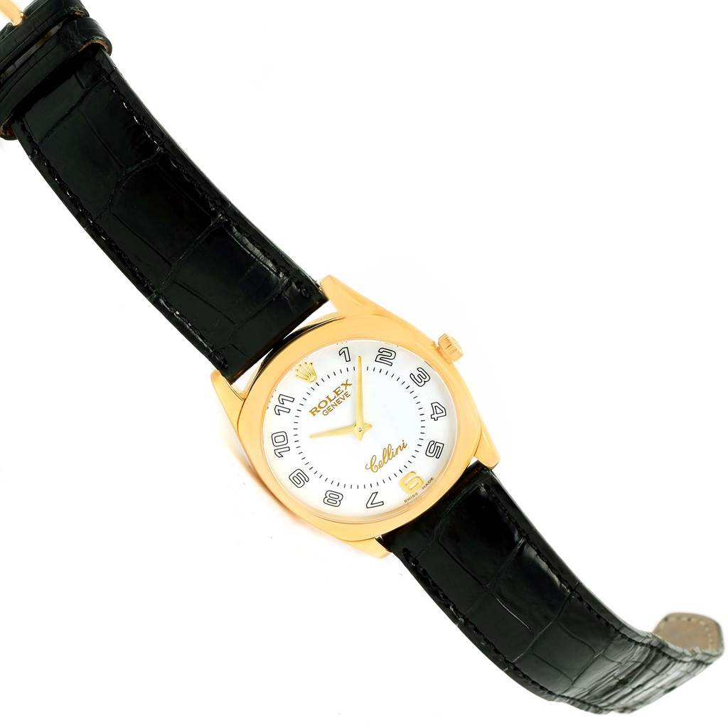 The image shows a top-down view of a Rolex Cellini 4233 Men's Yellow Gold White Dial 4233 Men's Yellow Gold White Dial watch with a black leather strap and gold casing.