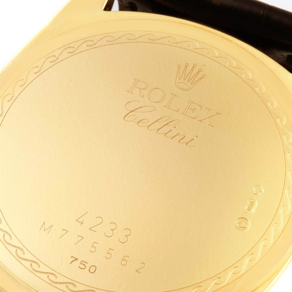 This image shows the back case of a Rolex Cellini 4233 Men's Yellow Gold White Dial 4233 Men's Yellow Gold White Dial watch, displaying engraved details and serial numbers.