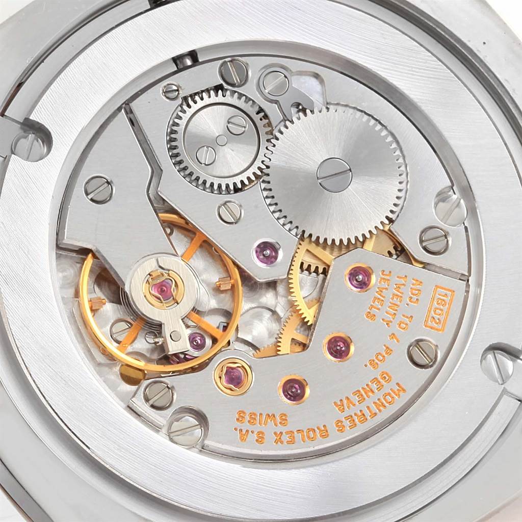 This image shows the intricate movement and gears of a Rolex Cellini 4233 White Gold Black Dial 4233 White Gold Black Dial watch from a close-up angle.
