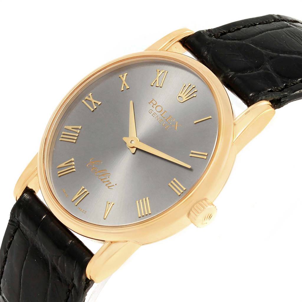 The Rolex Cellini 5116 Yellow Gold Grey Dial 5116 Yellow Gold Grey Dial watch is shown from an angled top view, displaying its face, golden case, crown, and black leather strap.