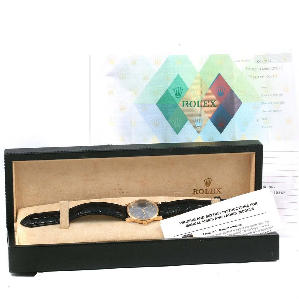 The Rolex Cellini 5116 Yellow Gold Grey Dial 5116 Yellow Gold Grey Dial watch is shown from a front angle, inside its box, with accessories including manuals and paperwork.