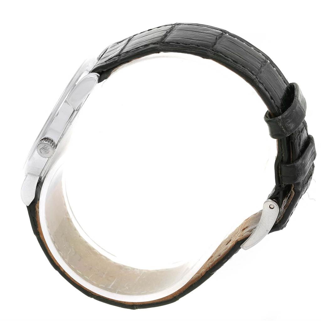 The image shows a side view of the Rolex Cellini 5116 Men's White Gold Grey Dial 5116 Men's White Gold Grey Dial watch with its crown and black leather strap visible.